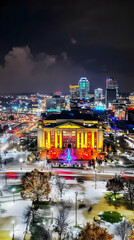 Fototapeta premium Vibrant Cityscape Illuminates Snowy Night with Colorful Lights and Modern Architecture