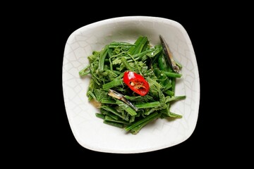 Fresh green vegetables with red chili garnish