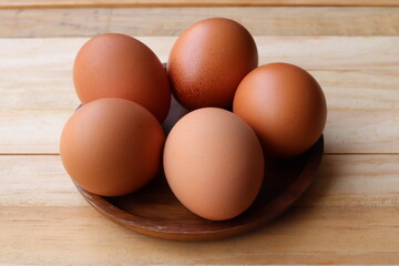 Fresh eggs on wood background
