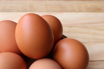 Fresh eggs on wood background