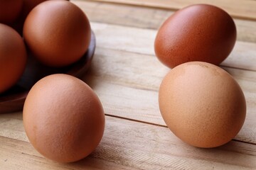 Fresh eggs on wood background