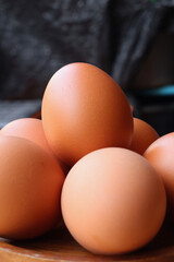 Fresh eggs on wood background