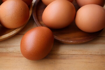 Fresh eggs on wood background