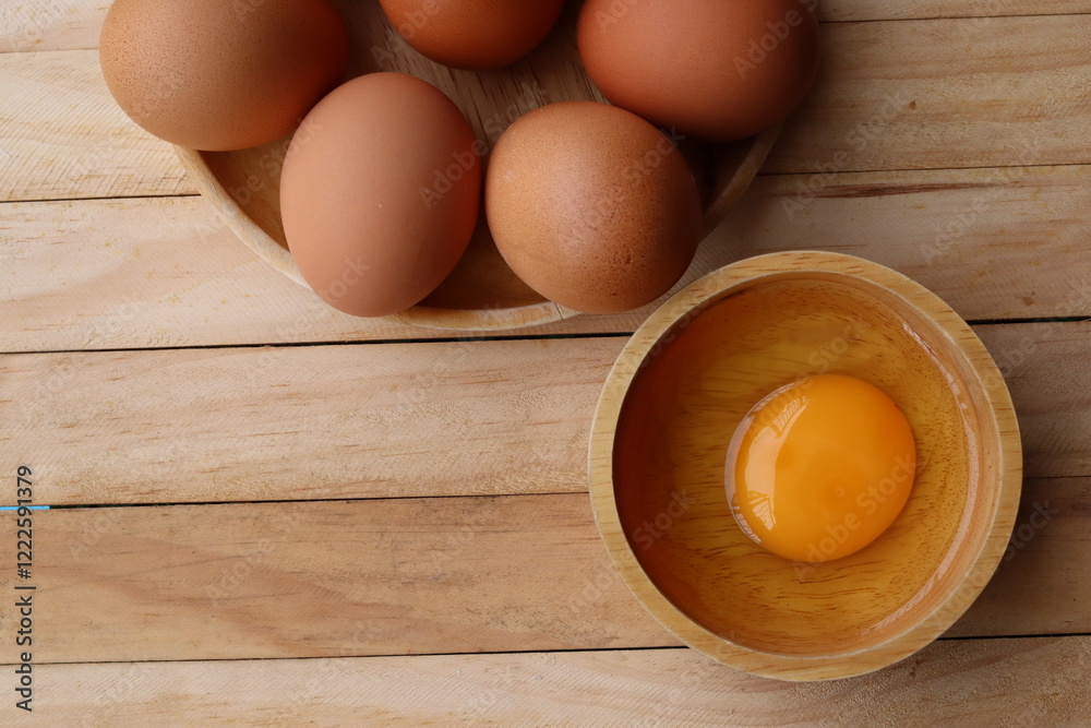 Wall mural Fresh eggs on wood background