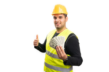 Happy construction worker showing like gesture presenting money