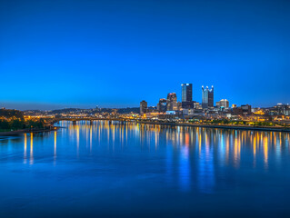 Fototapeta premium Cityscape Reflects in River at Twilight with Vibrant Colors across the Water Beautifully