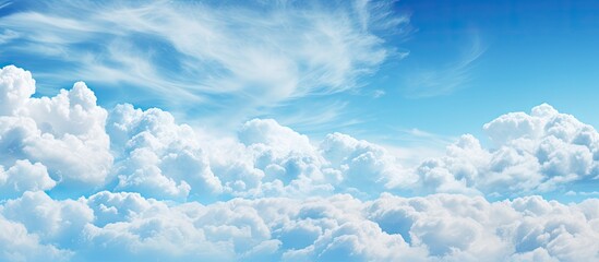 Bright blue sky with fluffy white clouds scattered across the upper third, creating a serene and uplifting atmosphere perfect for backgrounds.
