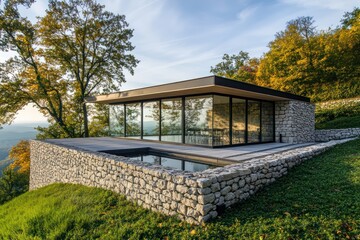 Fototapeta premium A minimalist hillside retreat with stone walls, a flat roof terrace, and a panoramic glass facade