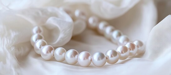 Elegant white freshwater pearl bracelet on soft white fabric, featuring lustrous pearls arranged gracefully to highlight their charm and beauty.