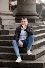 Young Man Posing Thoughtfully on Urban Steps