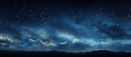 Panoramic night sky with deep blue hues and twinkling stars over mountainous landscape, featuring wispy clouds and a tranquil atmosphere.