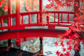 Vibrant red maple leaves gracefully frame a traditional japanese red bridge, creating a picturesque autumn scene