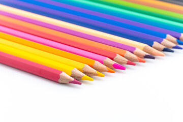 Colourful wooden colored pencils isolated on white background with copy space