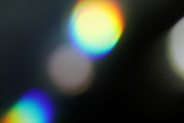 Colorful neon holographic light leaks on black background