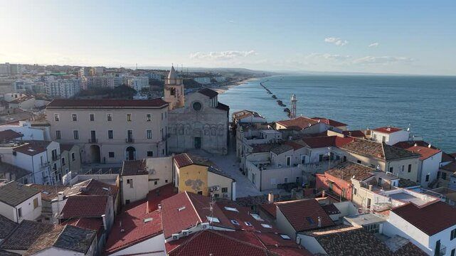 4k drone flight moving over the city footage (Ultra High Definition, 60fps) of old town of Termoli, Italy. Spectacular Termoli beach and picturesque Italian city on Adriatic sea.