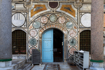 Akko, Israel - January 23, 2025, Entrance to Al-Jazeera Mosque decorated with ornamentation, shoe racks on the right.