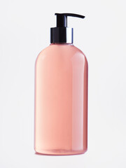 pink cosmetic product in a transparent bottle on a white background