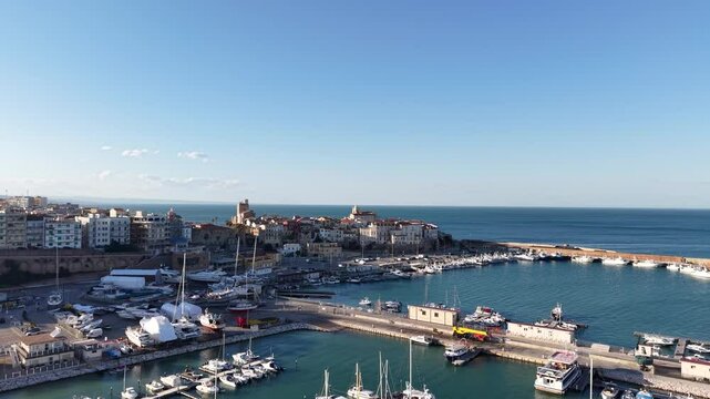 4k drone flight moving over the marina footage (Ultra High Definition, 60fps) of old town of Termoli, Italy. Spectacular Termoli marina and picturesque Italian seascape on Adriatic sea.