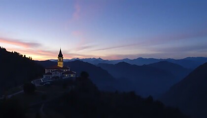 Obraz premium Illuminated Church on Mountain at Sunset Overlooking Distant Mountains