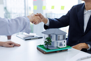 Handshake Real estate brokerage agent Deliver a sample of a model house to the customer, mortgage loan agreement Making lease and buy and sell house And contract home insurance mortgage loan concept	
