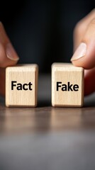 Two wooden blocks labeled "Fact" and "Fake" held by fingers, symbolizing truth vs. misinformation.