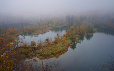 Plitvice Lakes in Croatia during autumn, showcasing stunning waterfalls, vibrant foliage, and crystal-clear waters, creating a magical and serene natural landscape perfect for nature lovers.