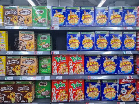 shelves with boxes of cereal products of various brands and types. high sugar food concept