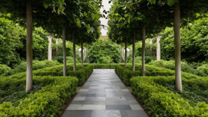 Obraz premium Lush garden with well-manicured shrubs and a gray tiled pathway, flanked by trees, creating a serene space for leisurely strolls or picnics.