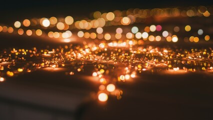 Blurred festive lights with warm orange and yellow hues scattered across a dark background, creating a magical bokeh effect and a cozy atmosphere.