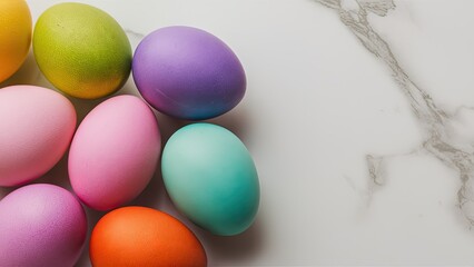 Colorful Easter eggs arranged in a cluster on a white marble surface with vibrant hues of pink, purple, blue, orange, and green in closeup detail.