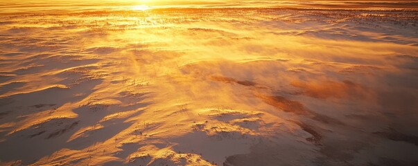 Obraz premium Golden sunset casting warm glow on snowy winter landscape