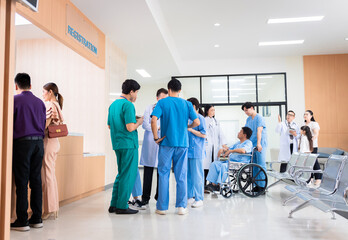 Medical staff and patients in a busy hospital reception services at information desk. many patients...