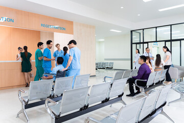 Medical staff and patients in a busy hospital reception services at information desk, atmosphere many patients wait for healthcare specialists in hospital. medical team doctors walking pass lobby
