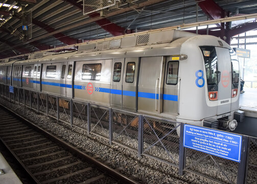 New Delhi, India, February 17 2024 - View inside Delhi metro station after the lockdown where wearing face mask is essential, Delhi Metro inside view during day time, Delhi Metro Train Crossing