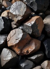 Fototapeta premium Geological Sample of Black and Dark Brown Obsidian Rocks, earthy textures, mineral samples