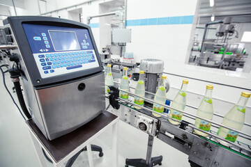 High-tech labeling machine in a modern beverage production facility ensuring efficient bottle...