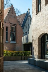 Naklejka premium Historic architecture meets modern design in a tranquil urban courtyard during a bright sunny day in the heart of the city