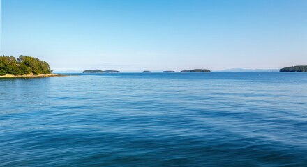 Serene view of calm blue waters and distant islands under a clear sky