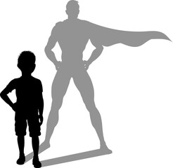 A superhero child or kid boy revealed by his shadow silhouette as a super hero in a cape.