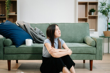 Obraz premium Asian woman sit Depression Dark haired pensive glance Standing by window and anxiety Copy space with a blanket
