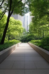 A path in a park with trees and a city in the background. The path is lined with trees and has a sidewalk