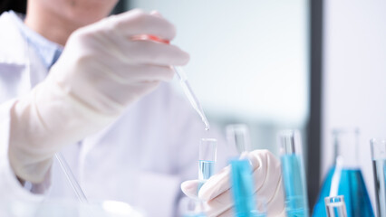 Fototapeta premium Close-up scientist pipette drop to test tube laboratory research chemistry chemical science research