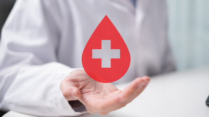 Professional health care worker doctor physician holding blood icon for blood donation concept