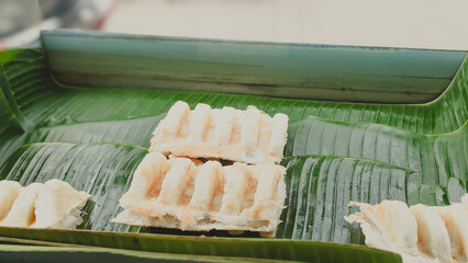 High angle view. The serving process of an authentic Indonesian traditional cake  famously known as Bandros or Gandos. Best served with crystal sugar