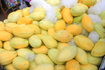 A pile of peeled mangoes for sale, street food, ready-to-eat fruits are widely available on the roadsides of Thailand.