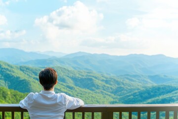 Fototapeta premium Smiling Woman Relaxing on Sunny Balcony with Scenic Mountain View