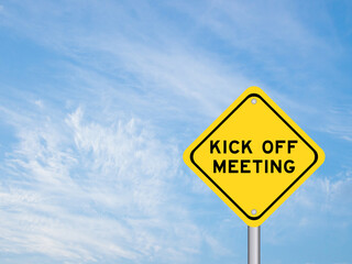 Yellow transportation sign with word kick off meeting on blue color sky background