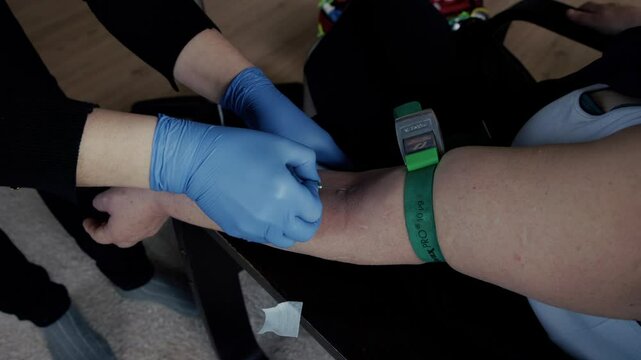 Nurse inserting a butterfly needle into patient's vein