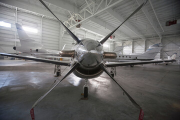 wide angle shot of front airplane propeller inside private airport hanger. Concept Aviation, Aircraft Engineering, Propeller Detail, Aerospace Technology, Mechanical Components  © Francisco