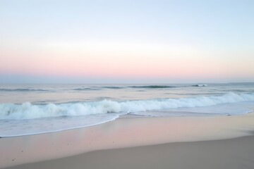Obraz premium A serene beach under a pastel sky, with the waves gently rolling onto the shore.